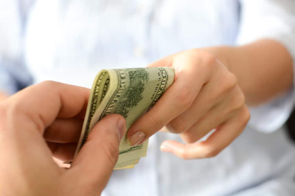 Woman receiving emergency cash from a relative