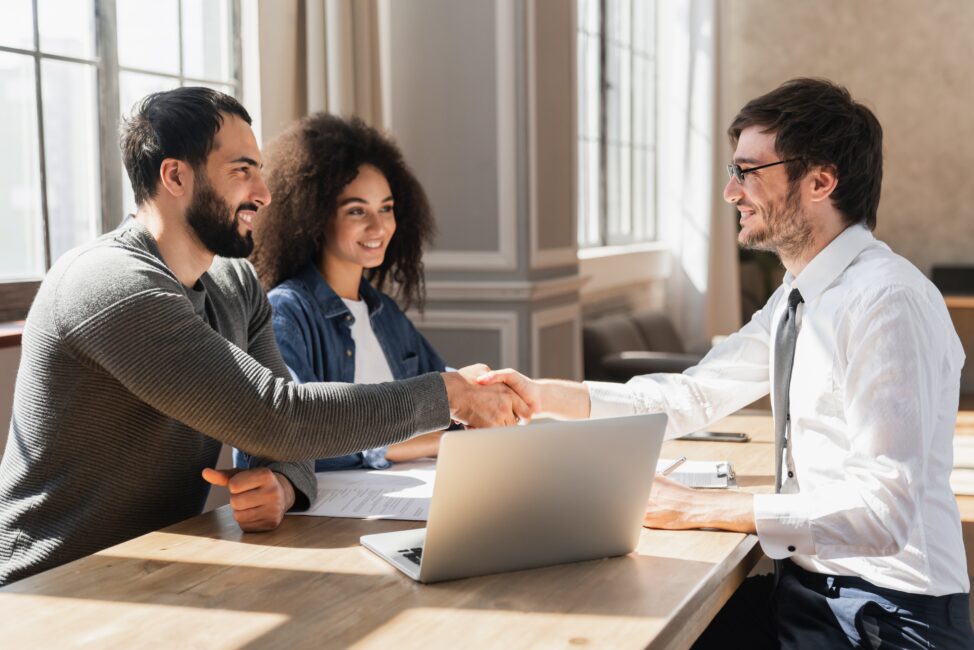 Couple shaking hands with a lender