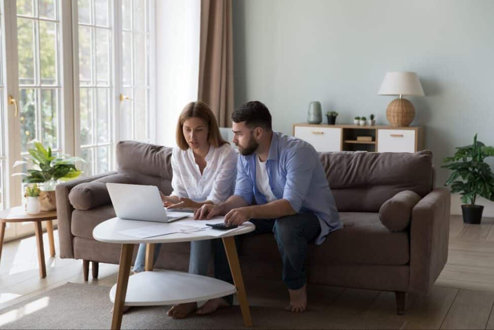 Serious husband and wife using the 30% rule to calculate rent payments 