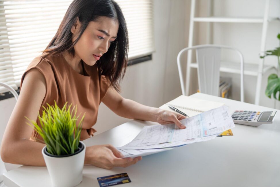 Young woman is stressed due to bills